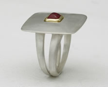  'Saturn Ring' with pyramid cut Ruby in silver and 18K yellow gold